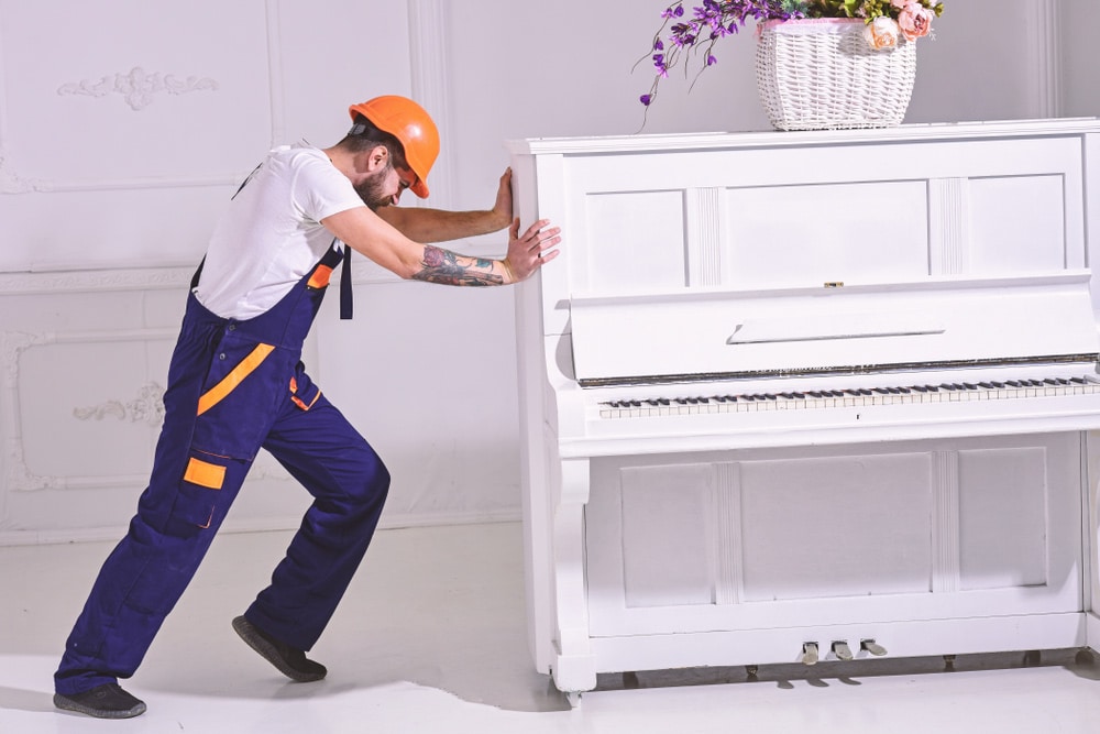 Man Moving A Piano