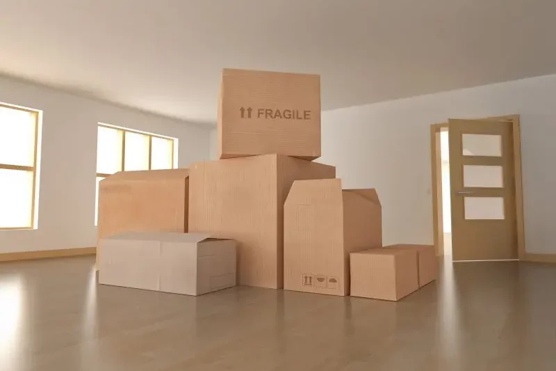 Removal Boxes In Empty Living Room — The Removals Group In Burleigh Heads, QLD